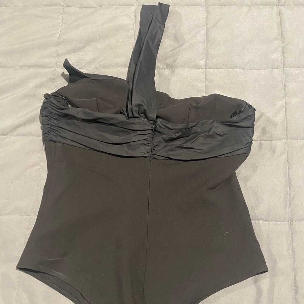 Black sleeveless bodysuit with big bow in front.